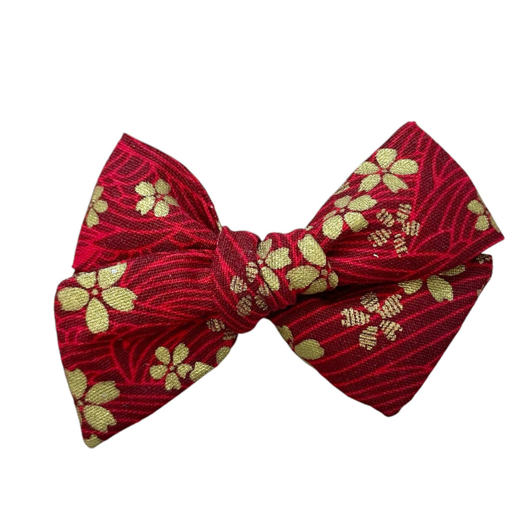 red & gold floral pinwheel bow